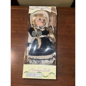 Porcelain‎ doll. 12” with layered dress, hat , pantaloons, and removable shoes